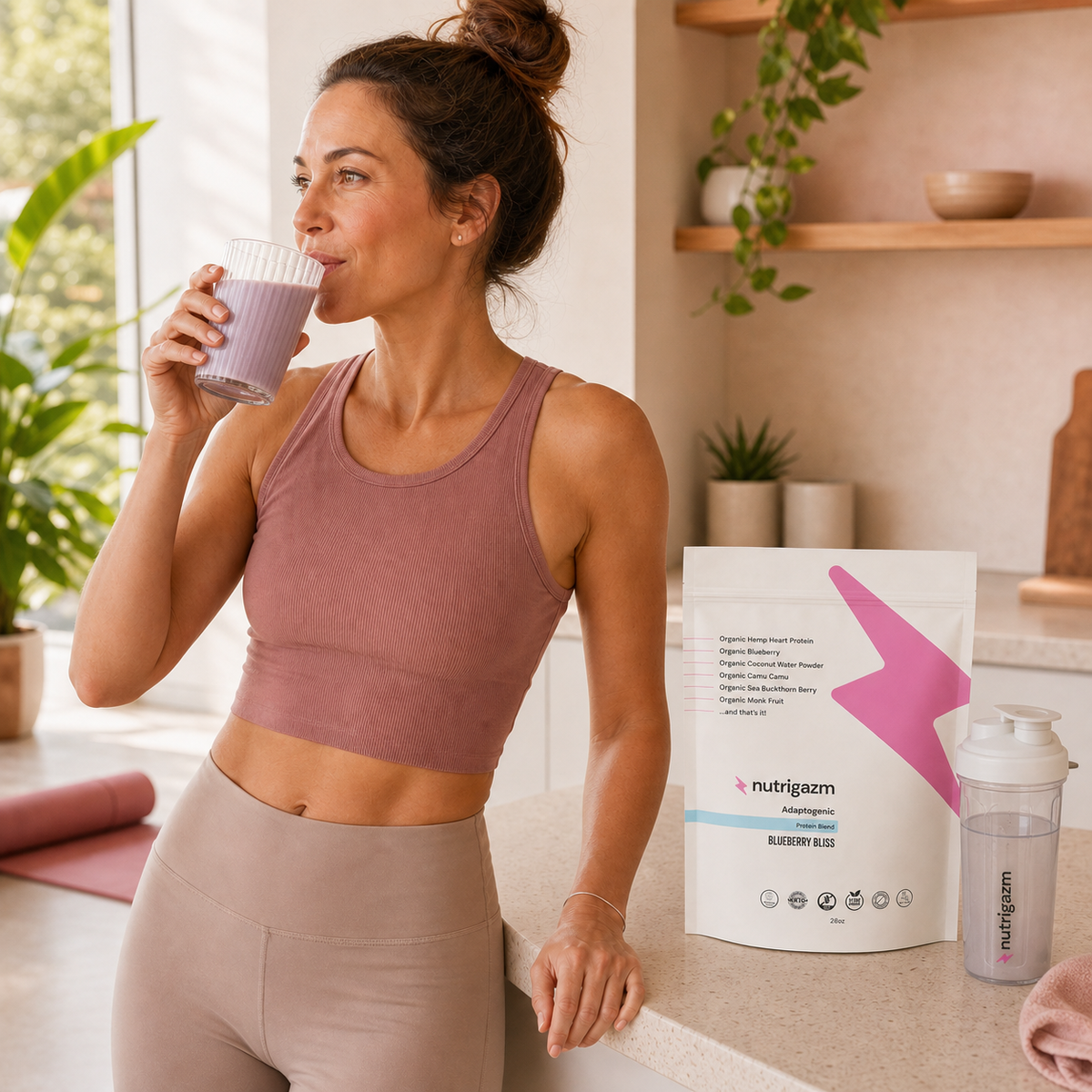 Woman enjoying a Blueberry Bliss protein shake after a morning workout